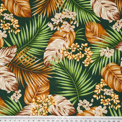 A Rose & Hubble floral design with tropical palm leaves on a forest green, 100% cotton poplin fabric with a cm ruler