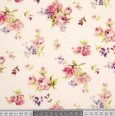 A delicate floral design on a cream cotton poplin fabric with a cm ruler
