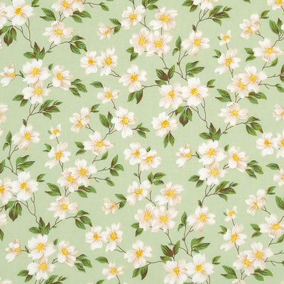 Pretty little white flowers are printed on a meadow green cotton poplin fabric by Rose & Hubble