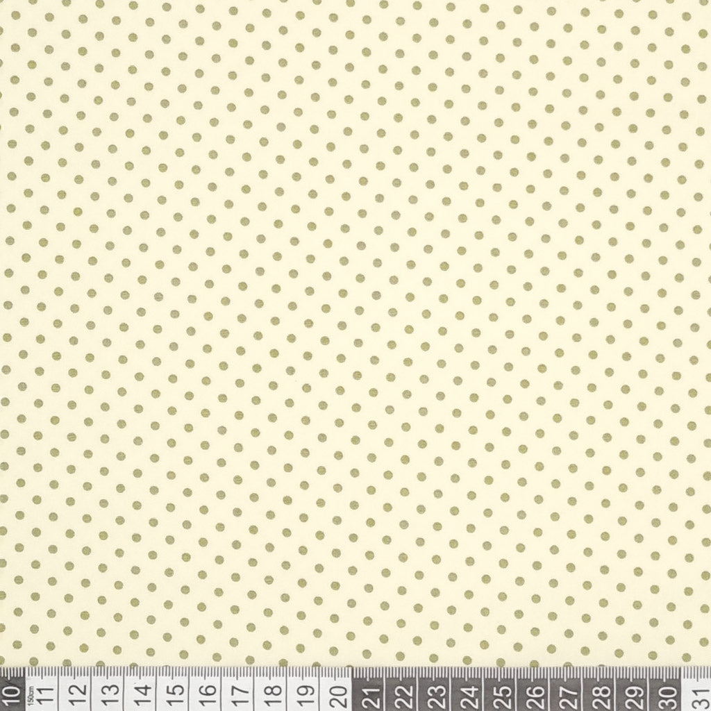 Green mini spots printed on a cream cotton poplin fabric