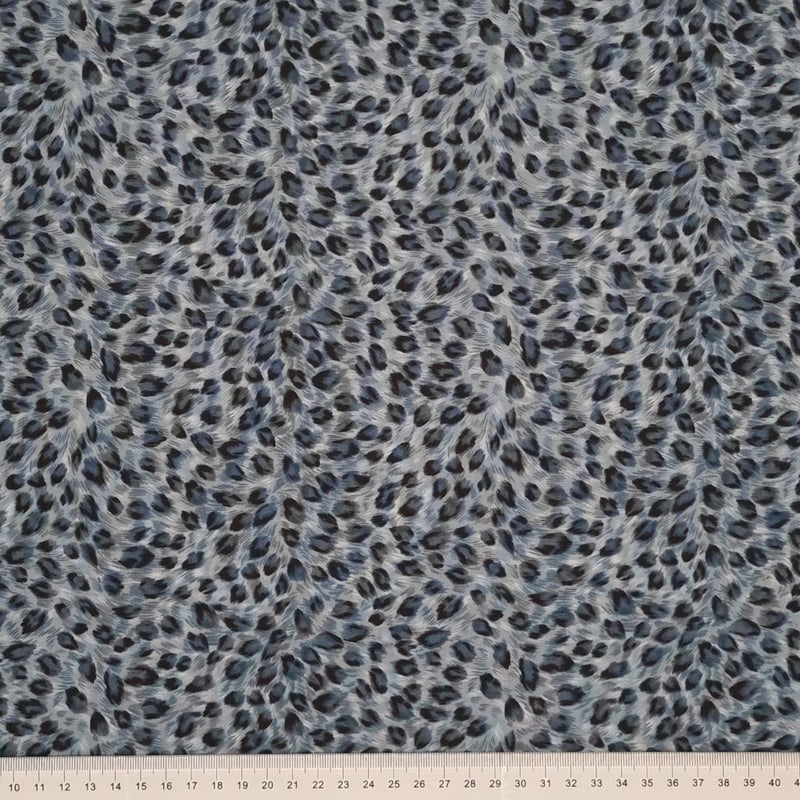 An animal print in grey on a 100% cotton poplin fabric by Rose & Hubble with a cm ruler at the bottom