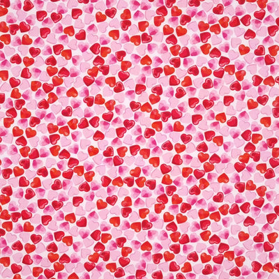 Small pink and red hearts are printed on a white, 100% cotton poplin by Rose & Hubble