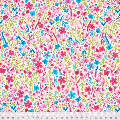 A Rose & Hubble floral design featuring vibrantly coloured ditsy flowers on an ivory, 100% cotton poplin fabric with a cm ruler at the bottom