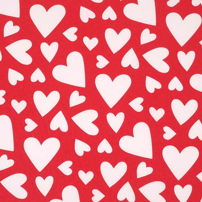 Multi sized white hearts printed on a red cotton poplin fabric