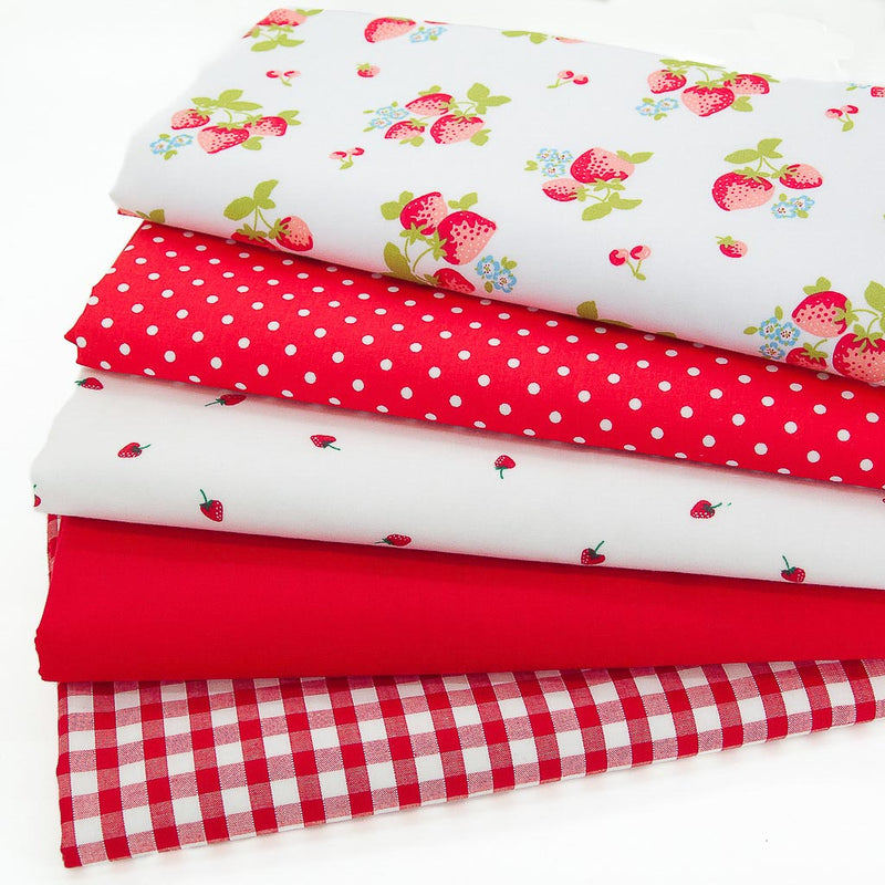 A fat quarter bundle with strawberries, spots and red gingham