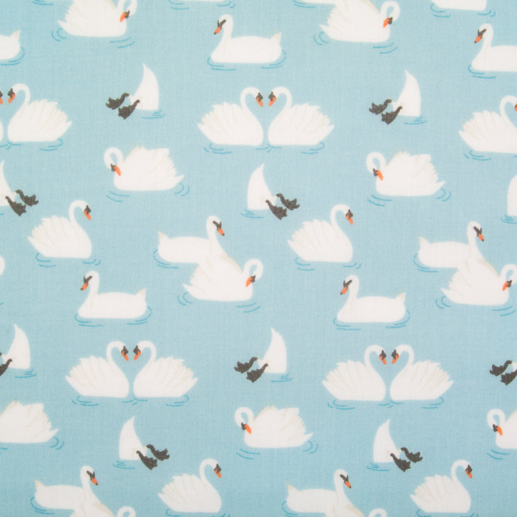 Swans printed on a blue polycotton fabric