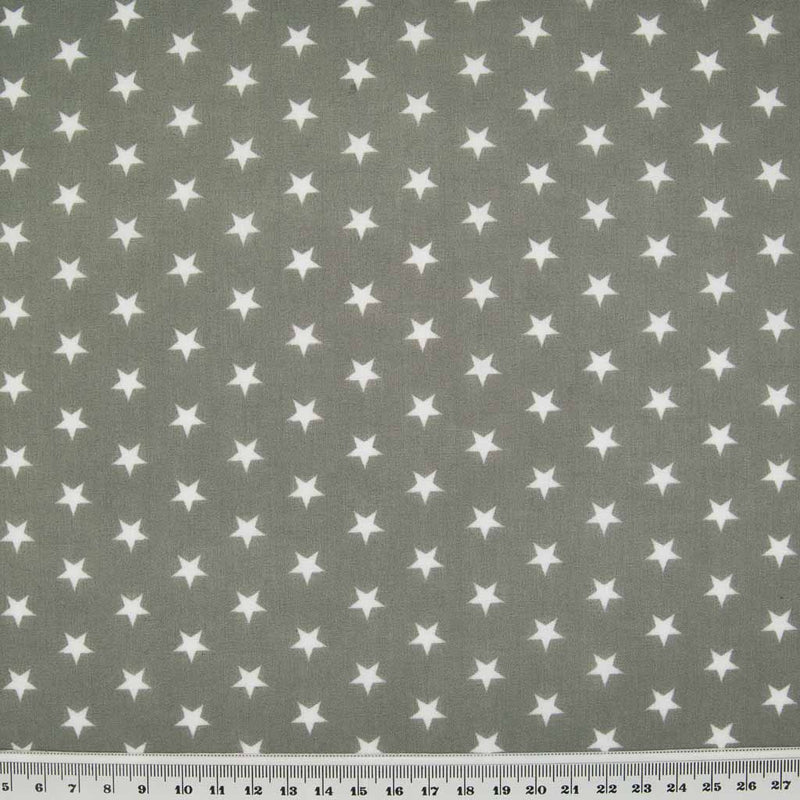 10mm white stars are printed on a grey polycotton fabric with a cm ruler at the bottom