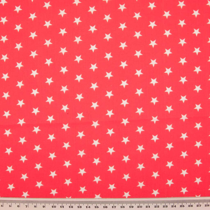 10mm white stars are printed on a red polycotton fabric with a cm ruler at the bottom