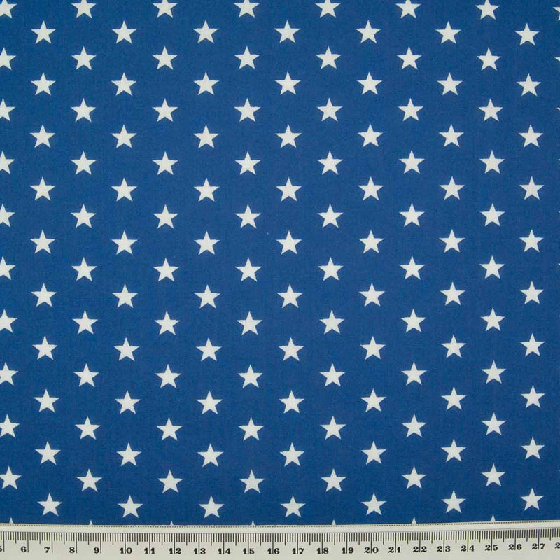 10mm white stars are printed on a royal blue polycotton fabric with a cm ruler at the bottom