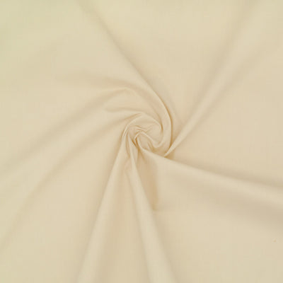 A plain beige coloured polycotton. 110cm wide