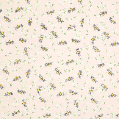 Bees and white daisies are printed on a cream polycotton fabric