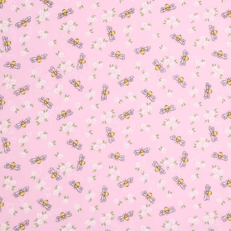 Bees and white daisies are printed on a pink polycotton fabric