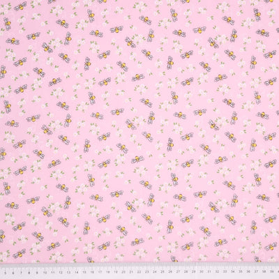 Bees and white daisies are printed on a pink polycotton fabric with a cm ruler at the bottom
