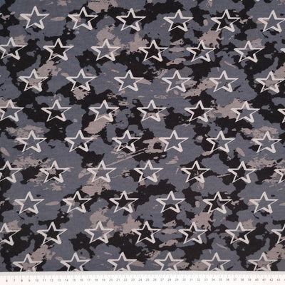 Stars are printed on an urban camo soft sweat jersey fabric in black and grey colourway with a cm ruler at the bottom