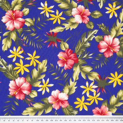 A tropical sunshine floral design printed on an indigo, lightweight cotton poplin fabric with a cm ruler