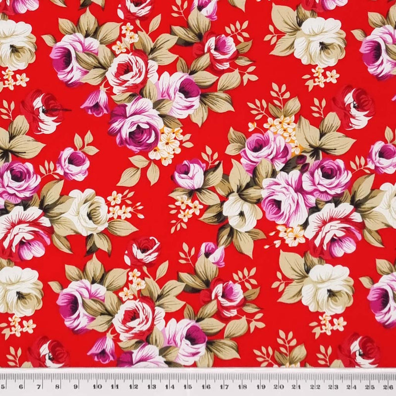 Sprays of lilac roses with sage green leaves printed on a red, lightweight cotton poplin fabric with a cm ruler