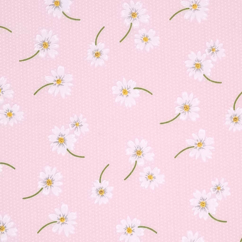 White daisies in a scattered pattern are printed on a pink polycotton fabric with tiny white spots