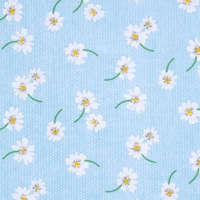 White daisies in a scattered pattern are printed on a sky blue polycotton fabric with tiny white spots.