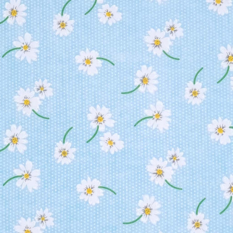 White daisies in a scattered pattern are printed on a sky blue polycotton fabric with tiny white spots.