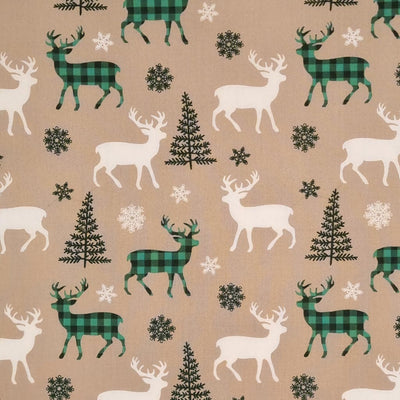 Green check reindeer with ivory reindeer and green christmas trees are printed on a beige 100% cotton fabric