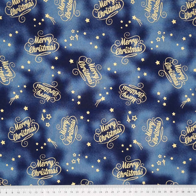 Printed metallic shooting stars and regular stars surround the text 'Merry Christmas' on this navy 100% cotton marbled effect fabric with a cm ruler at the bottom