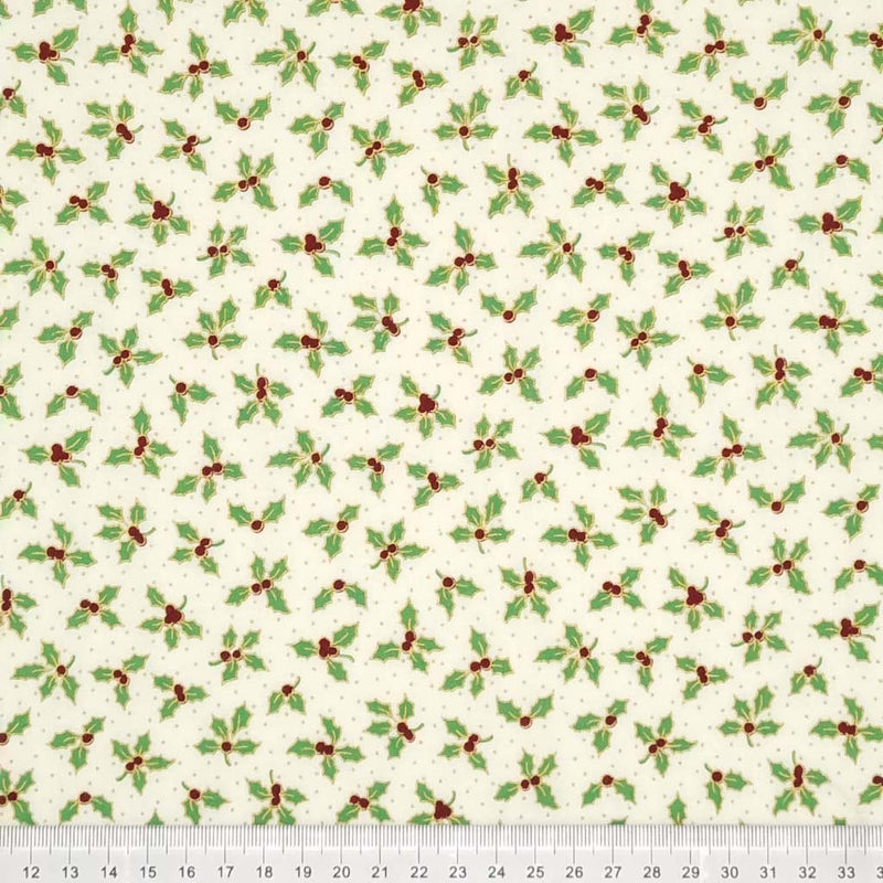 Small holly leaves with red berries are printed on an ivory 100% cotton fabric with a cm ruler