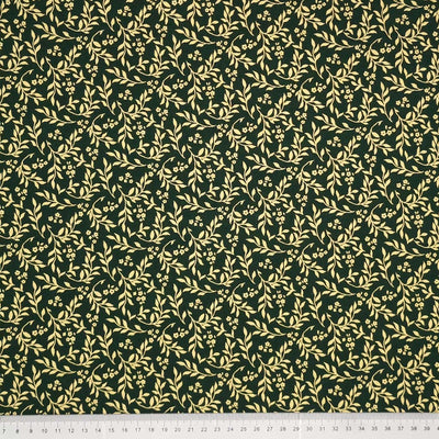 Printed gold metallic wreath leaves and flowers are printed on this green 100% cotton fabric with a cm ruler at the bottom