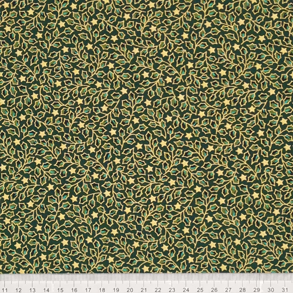 Mini holly leaves and stars in gold lacquer printed on a green christmas cotton fabric with a cm ruler
