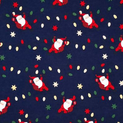 Santa hanging from festive fairy lights with metallic stars printed on a navy 100% quality cotton fabric by Rose & Hubble