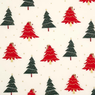 Red and green christmas trees with strings of lights printed on an ivory cotton fabric