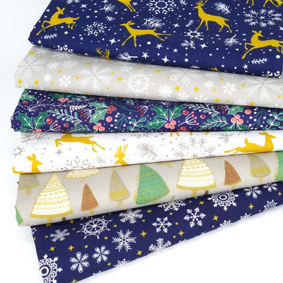 A christmas fat quarter bundle of 6 christmas designs including reindeer, snowflakes and holly in a navy, white, silver and gold colourway.