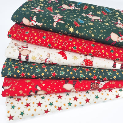 6 christmas cotton fabrics in a fat quarter bundle featuring stars and reindeer