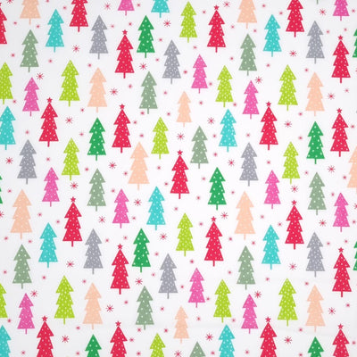 Colourful christmas trees in reds and greens are printed on a white polycotton fabric