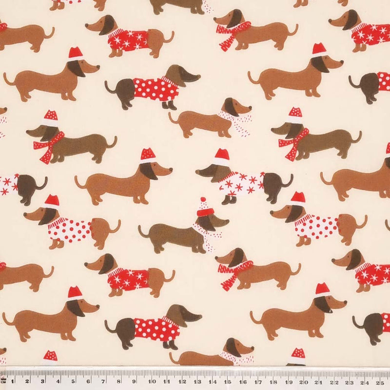 Dachshund sausage dogs in christmas jumpers printed on a navy polycotton fabric with a cm ruler