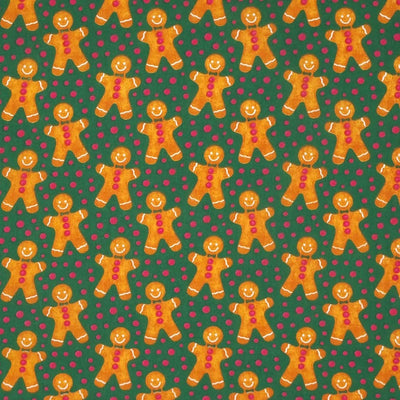 Happy gingerbread men surrounded by red spots are printed on a green polycotton fabric.