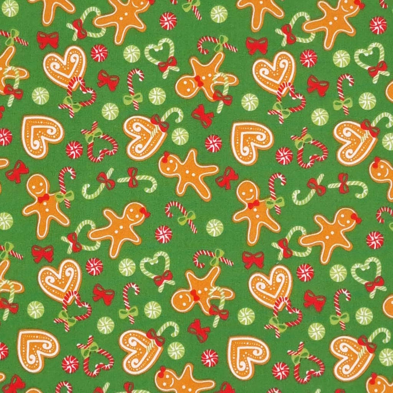 Cute gingerbread men, candy canes and hearts on a green polycotton fabric. 