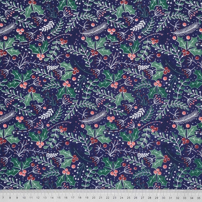 holly leaves and berries are surrounded by festive leaves and are printed on a navy polycotton fabric with a cm ruler at the bottom
