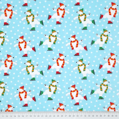 Happy skating polar bears are printed on an ice blue polycotton fabric with a cm ruler at the bottom