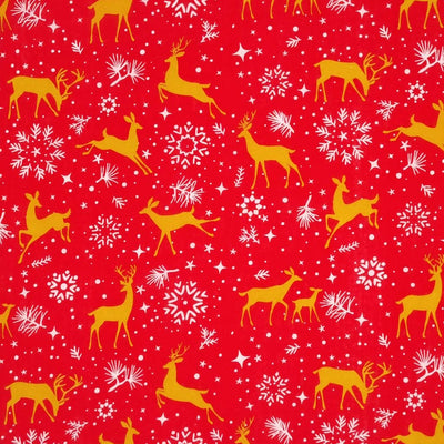 Prancing christmas reindeer with pretty stars and snowflakes are printed on a red polycotton fabric