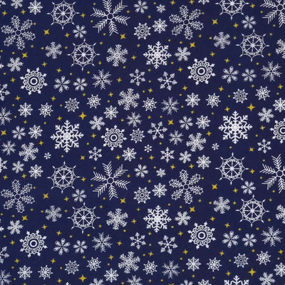 falling snowflakes and gold stars are printed on a navy polycotton fabric