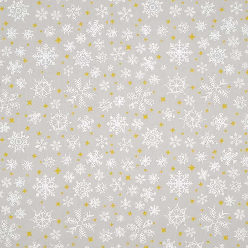 falling snowflakes and gold stars are printed on a silver polycotton fabric
