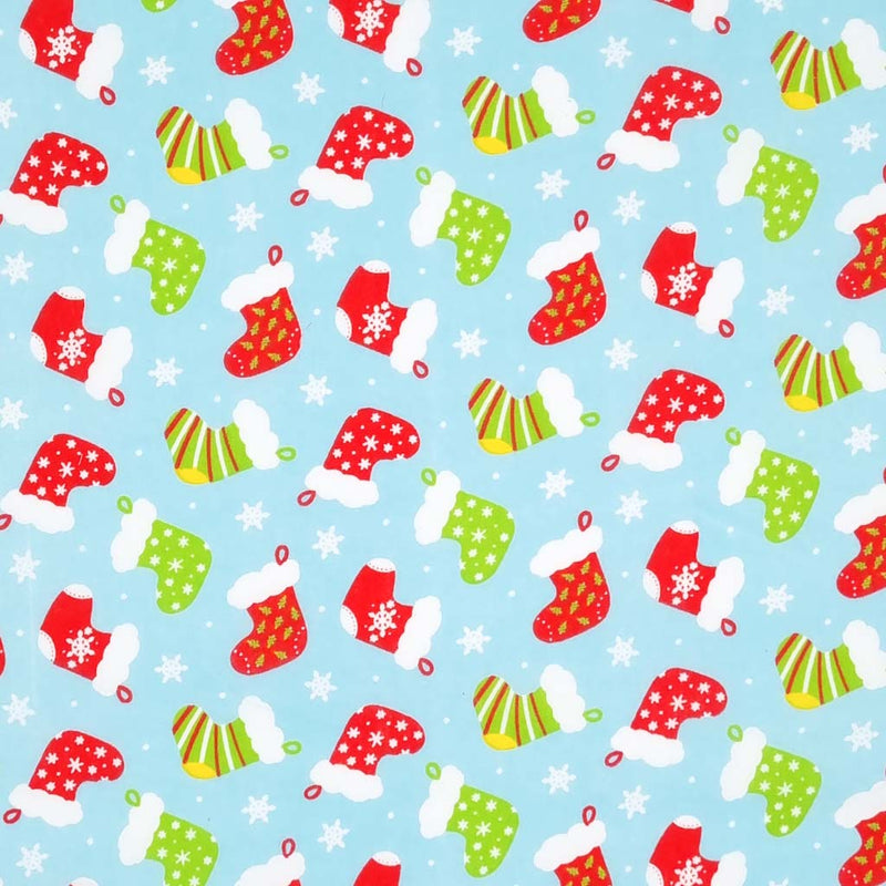 Red and green christmas stockings are printed on a light blue polycotton fabric.