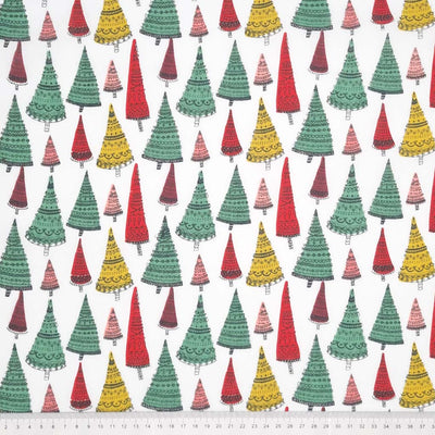 Intricate hand-drawn Christmas trees are printed on a white polycotton fabric with a cm ruler at the bottom