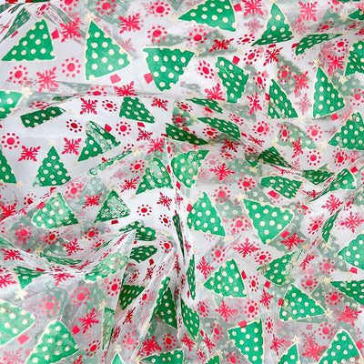 Glittery green christmas trees printed on a clear organza fabric