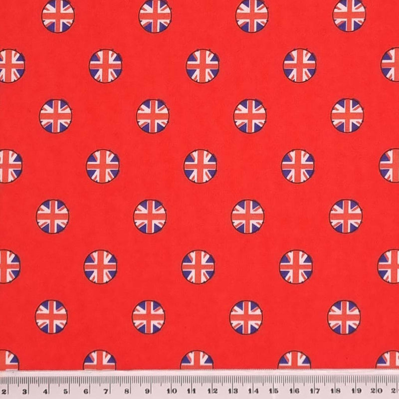 Union jack flags in small circles are printed on a good quality, cotton rich, red polycotton fabric with a cm ruler