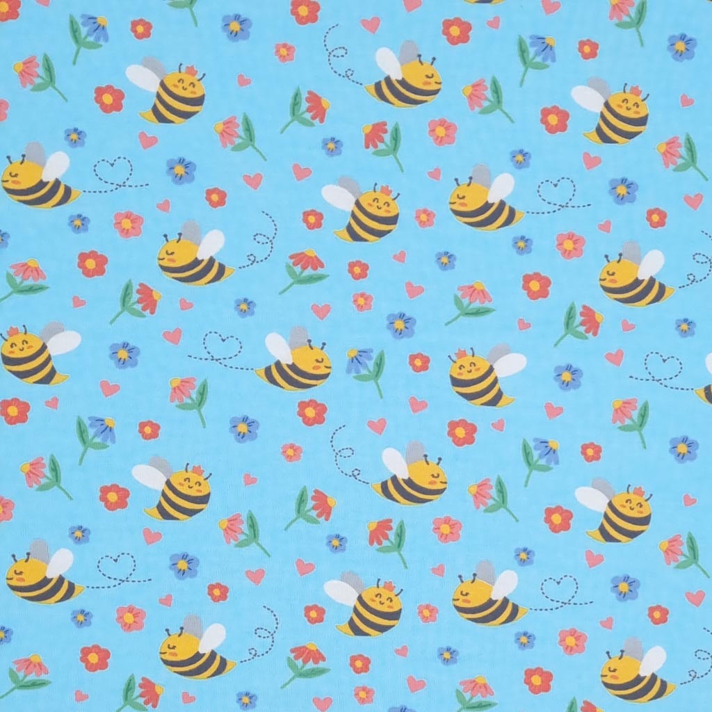 Smiling bees, flowers and hearts printed on a sky blue cotton jersey fabric
