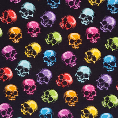 Scattered brightly coloured skulls are digitally printed on a quality black 100% Cotton fabric.