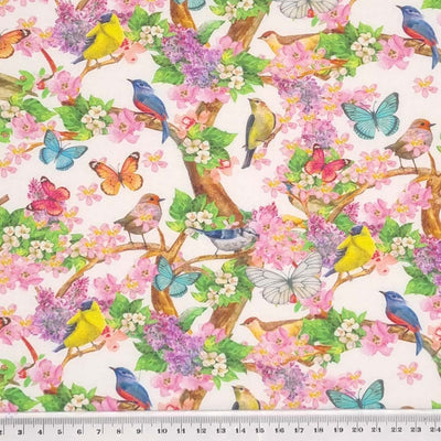 Colourful birds, butterflies and flowers printed on a white cotton fabric with a cm ruler