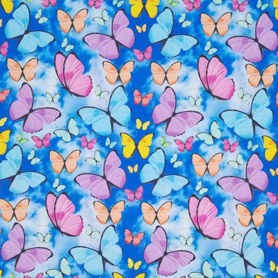 Brightly coloured flying butterflies are digitally printed on a quality clouded sky 100% cotton fabric.