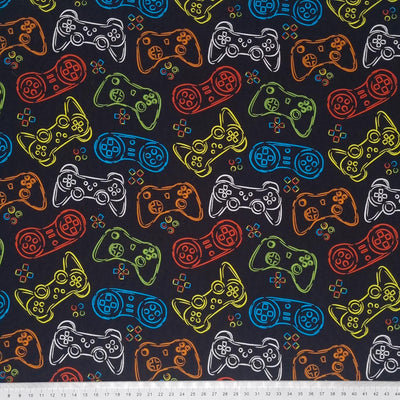 Blue, red, orange, yellow and green game controllers are digitally printed on a quality black 100% cotton fabric with a cm ruler at the bottom
